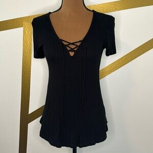 Black tunic with tie front. Short sleeve. Small. Ribbed.